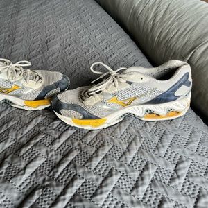 Size 12.5 Mizuno Running Shoes. Been worn a bit but still in decent shape.